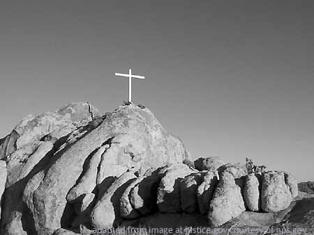 Cross Atop Rocky Desert Cliff, adapted from image at justice.gov