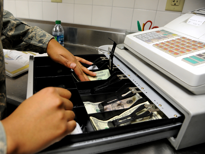 Cash Register with Open Drawer and Cash, Handled by Cashier in Military Uniform