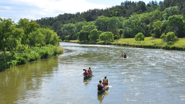 Nebraska Countryside Include River With Canoes and Paddlers adapted from nps.gov image